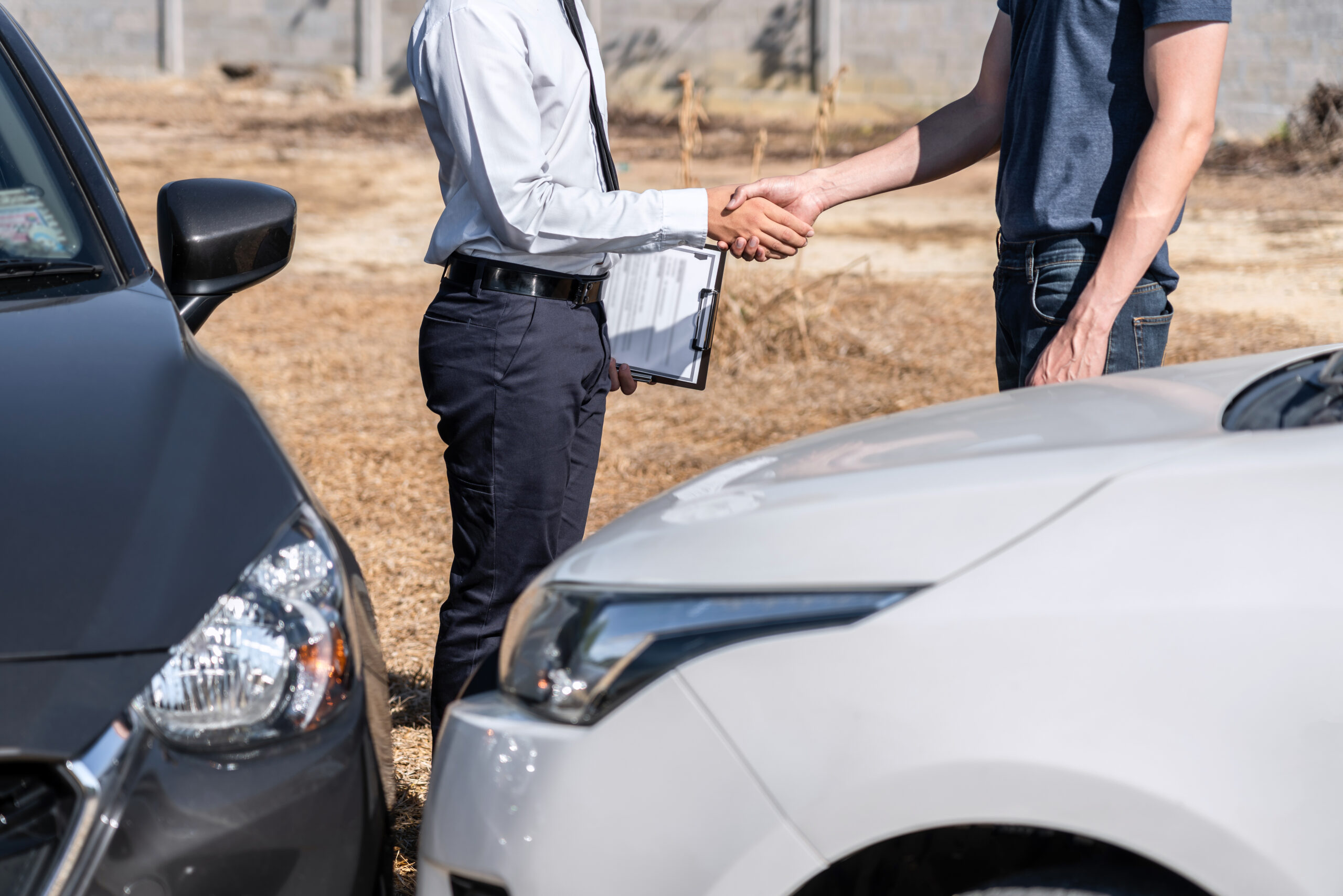 Insurance Agent and customer shaking hands after agreement about